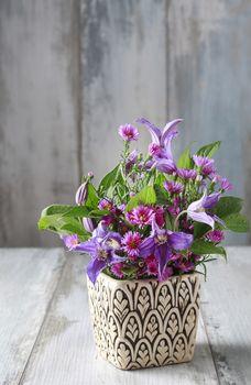Kwiaty w doniczce na drewnianym tle